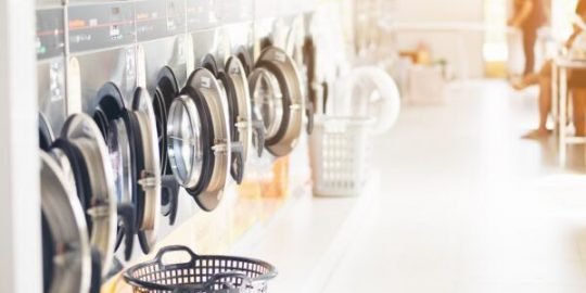 commercial laundry machines in row